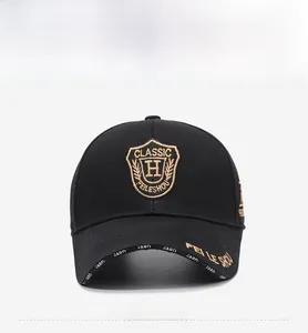 Detail of gold shield embroidery and H-classic lettering on a black baseball cap