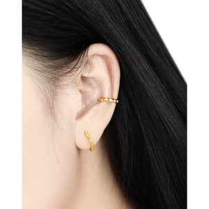 Minimalist gold geometric gear ear cuff set with stud texture on a female model