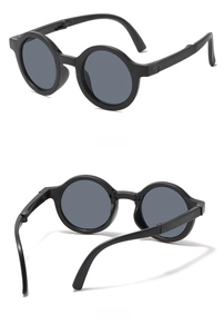 Detail showing foldable hinge design of kids round frame sunglasses with matte black finish