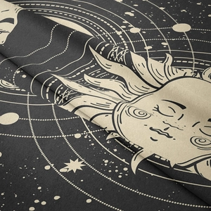 Close-up of woven fabric texture showing sun and moon celestial patterns on wall tapestry