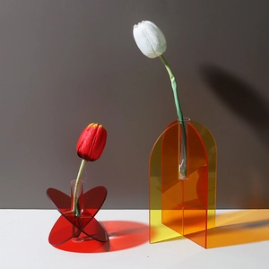 Minimalist colorful acrylic vases in red and yellow with transparent artistic shadows