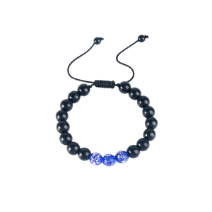 Close-up of adjustable beaded bracelet with blue glass beads and gold foil details