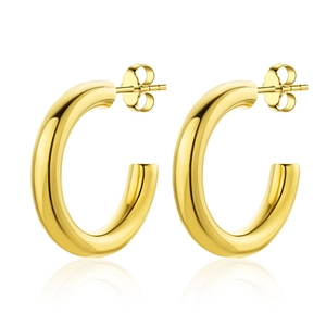 Detailed view of polished gold chunky hoop earrings with butterfly backs on white surface