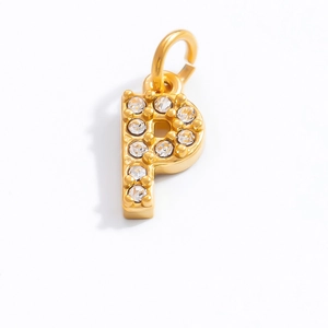 Macro shot of gold-plated letter P pendant with sparkling clear cubic zirconia stones