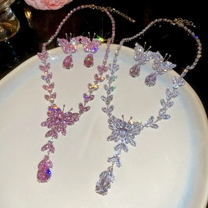 Macro shot of butterfly tassel jewelry set with pink and silver zircon stones