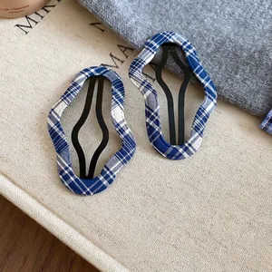 Set of two wavy blue plaid fabric hair clips with minimalist checkered pattern for women
