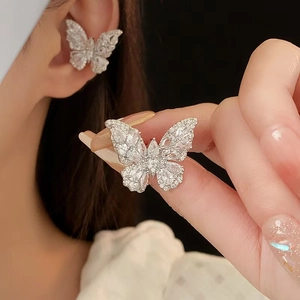 Macro shot of silver butterfly ear clip encrusted with sparkling zircon stones