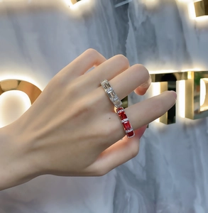 Close-up of S925 sterling silver rings with emerald cut red and white gemstones