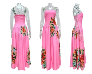 Detail view of pink floral maxi dress featuring thin green straps and backless design
