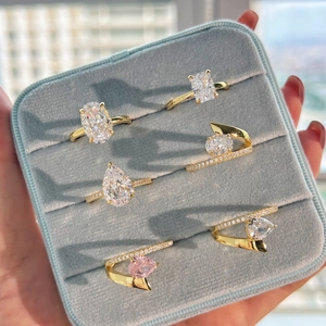 Selection of luxury zircon rings with pear and oval cuts presented in a soft velvet box