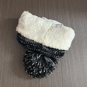Detail view of winter knit hat with 100% acrylic fiber and white warm faux fleece lining