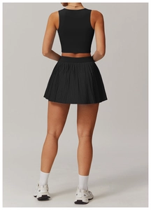 Rear view of black pleated tennis skirt and racerback crop top sports set for women