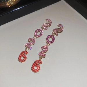 Détail des boucles d'oreilles 2026 avec strass dégradés roses et base en aiguille d'argent