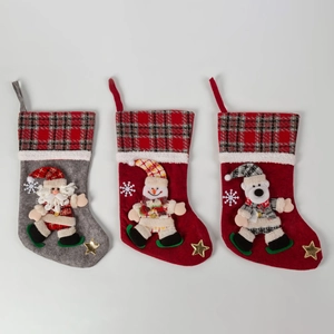 Three festive Christmas stockings with Santa, snowman and reindeer figures in plaid style