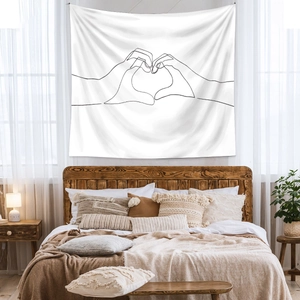 Detail of minimalist line art tapestry featuring hand-heart design on a bedroom wall