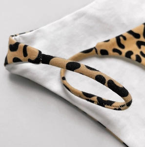 Macro detail of the high-density leopard print cotton fabric and fine stitching craftsmanship