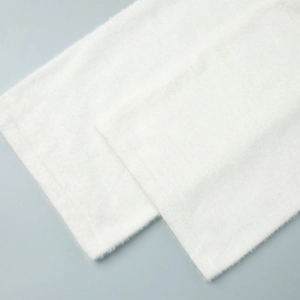 Close-up detail of white plush knit fabric texture with soft faux mink wool feel