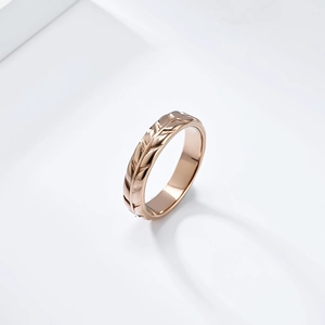 Macro detail of tulip flower leaf engraving on rose gold stainless steel ring