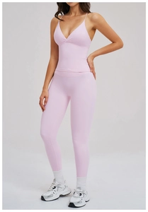 Detail of light pink yoga set featuring a V-neck strappy tank top and high-waist leggings