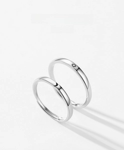Detailed close-up of S925 sterling silver couple rings with sun and moon engravings