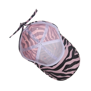 Detailed interior of zebra print cotton baseball cap with stitch lines and size tag