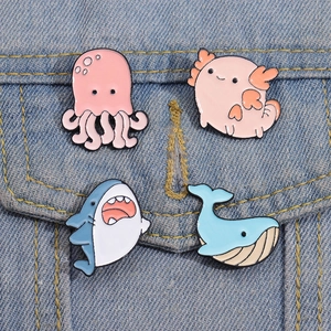 Cute marine animal enamel pins set with pink octopus and shark on blue denim jacket