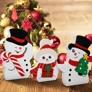 Detailed view of three festive wooden snowmen figurines for Christmas home decor