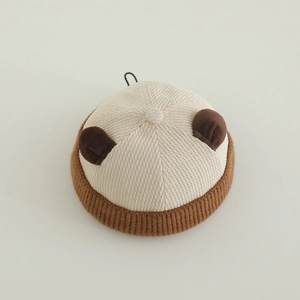 Close-up of baby beanie with plush brown bear ears and ribbed knit brim texture
