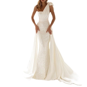 Detail of sequin patchwork and satin draping on ivory shoulder evening gown