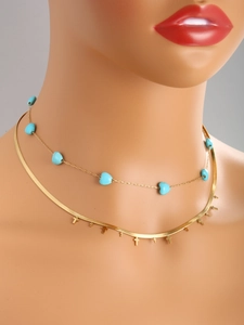 Detail showing 14K gold-plated layered necklace with turquoise heart beads and crosses