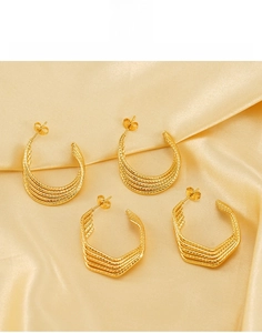 Detailed macro view of 18k gold plated stainless steel U-shaped layered hoop earrings