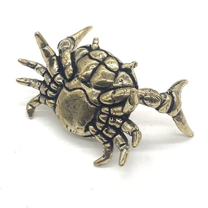 Macro shot of vintage bronze crab figurine with detailed antique textured finish