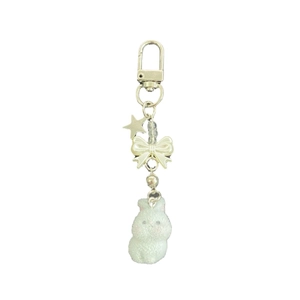 Cute fluffy white bunny keychain with cream bow and silver star on white background