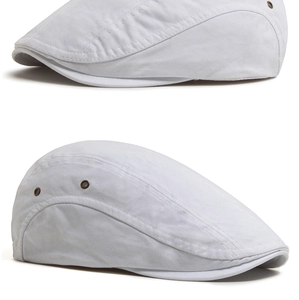 Detailed side view of a white vintage cotton flat cap with ventilation eyelets
