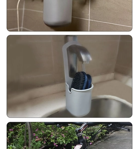 Multi-purpose grey silicone holder used on a kitchen faucet and bicycle handlebar