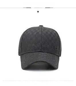 Detail of dark gray baseball cap with fine grid pattern and metal side ornament