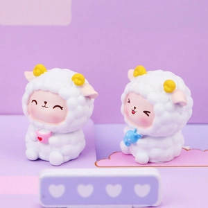 Close-up of two cute white resin sheep figurines with pink cheeks and heart cup and candy