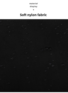 Close-up of waterproof black nylon material showing quilted stitching and water droplets