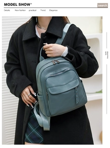 Detail of teal PU leather backpack with side rivet studs and multiple zipper pockets