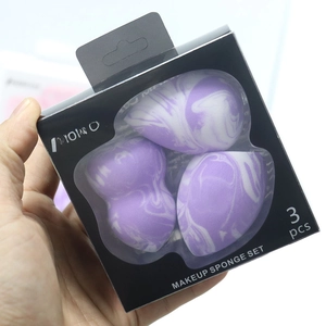 Detailed view of three-piece marble purple makeup sponge set in black display box