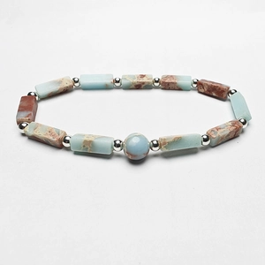 Detailed close-up of rectangle natural blue stone beads with silver spacer accents