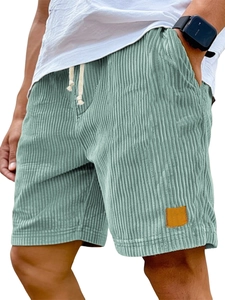 Detail showing wide corduroy texture and premium leather patch on casual men's shorts