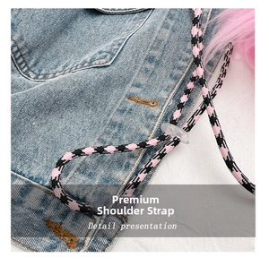 Detail of adjustable strap with pink weave and soft faux fur on denim crossbody bag