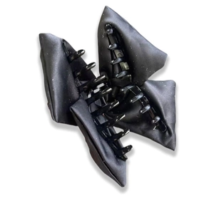 Detail shot of the black satin double-layer bow hair claw with a subtle shimmering finish