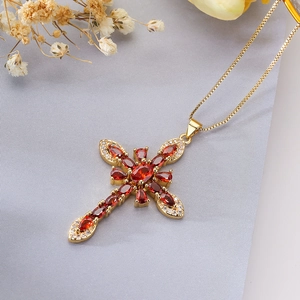 Detailed close-up of 18K gold plated cross pendant with red marquise cubic zirconia