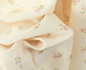 Detailed macro view of yellow floral chiffon fabric with soft rose and purple patterns
