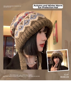Detailed knit texture and retro geometric patterns on warm earflap beanie with ties