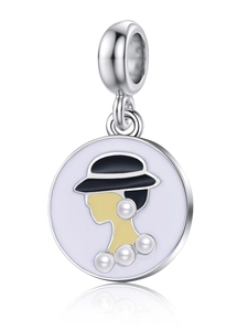 Macro shot of silver enamel charm pendant featuring a lady silhouette and faux pearl inlay