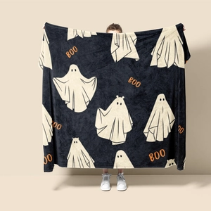 Detail of soft black flannel blanket with white ghost patterns and orange BOO text