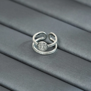 Macro shot of silver double-layered clover ring with pavé zircons and open design